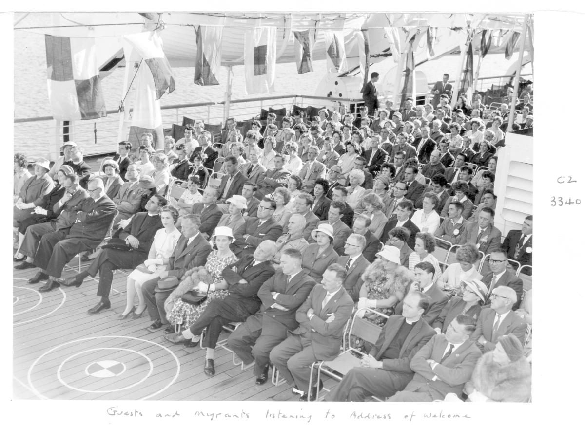 1959 Centenary celebrations - Migrant ship "Orion", guests and migrants listening to address of welcome - Brisbane, August 1959