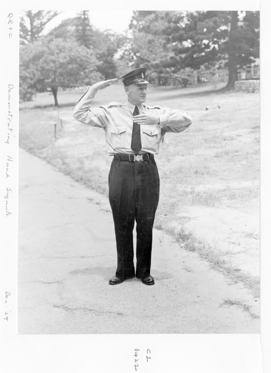 Demonstrating traffic hand signals - Brisbane, December 1959