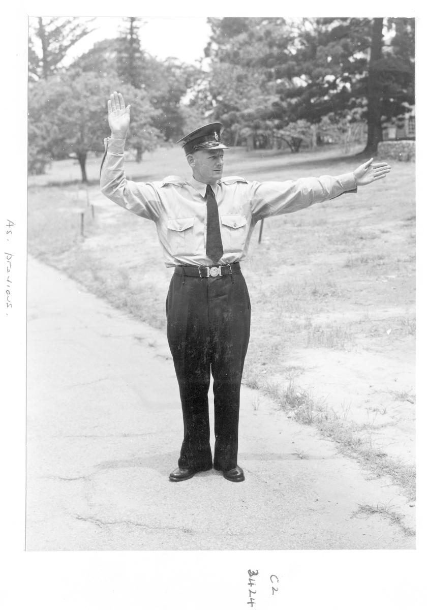 Demonstrating traffic hand signals - Brisbane, December 1959