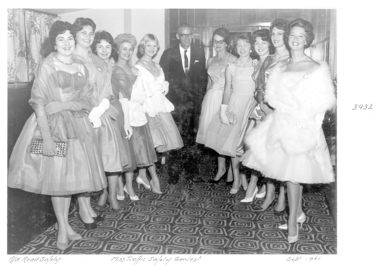 Miss Traffic Safety Quest 1961 contestants in evening dress, with judge - Brisbane, September 1961