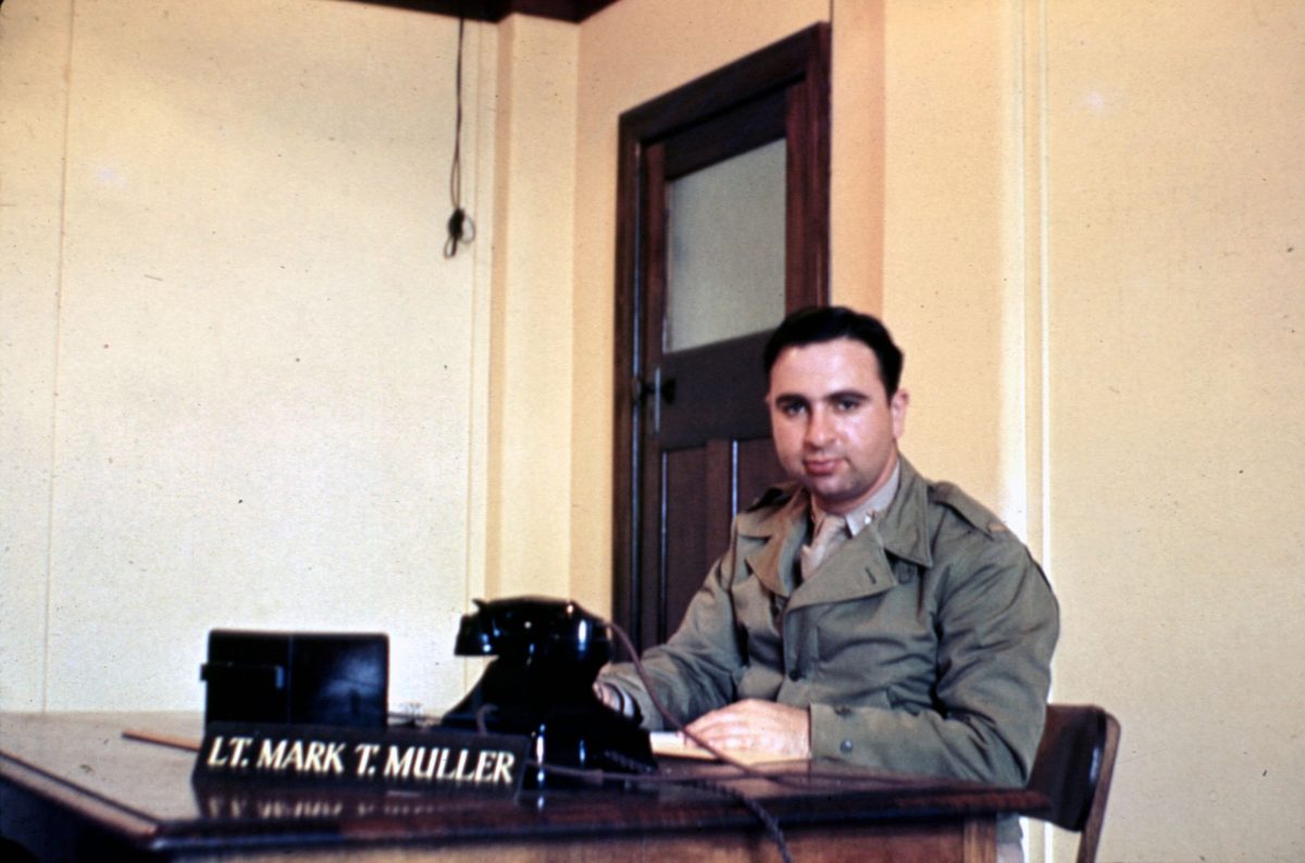 American Lieutenant Mark T. Muller, assistant signal officer, behind his desk in Somerville House, Brisbane, 1942