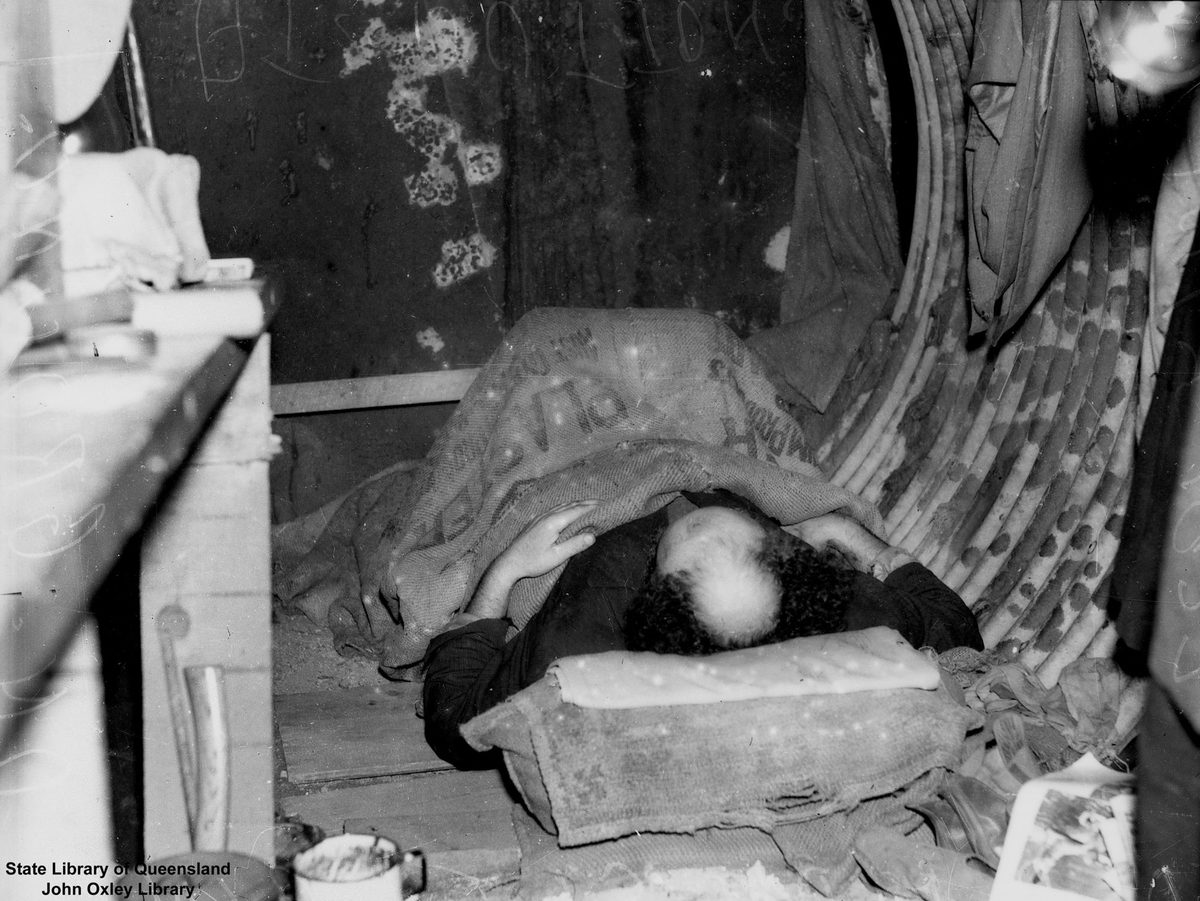 Homeless man sleeping on the ground at Dutton Park, Brisbane, 1937
