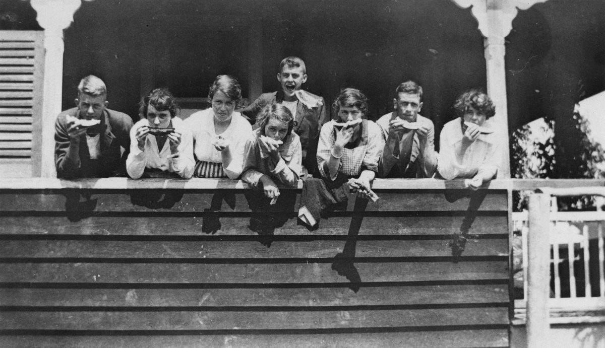 Family eating watermelon at Woody Point, 1920