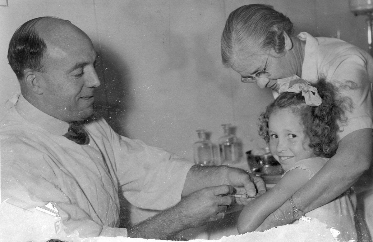 Little girl puts on a brave face for her vaccination, Brisbane, 1954