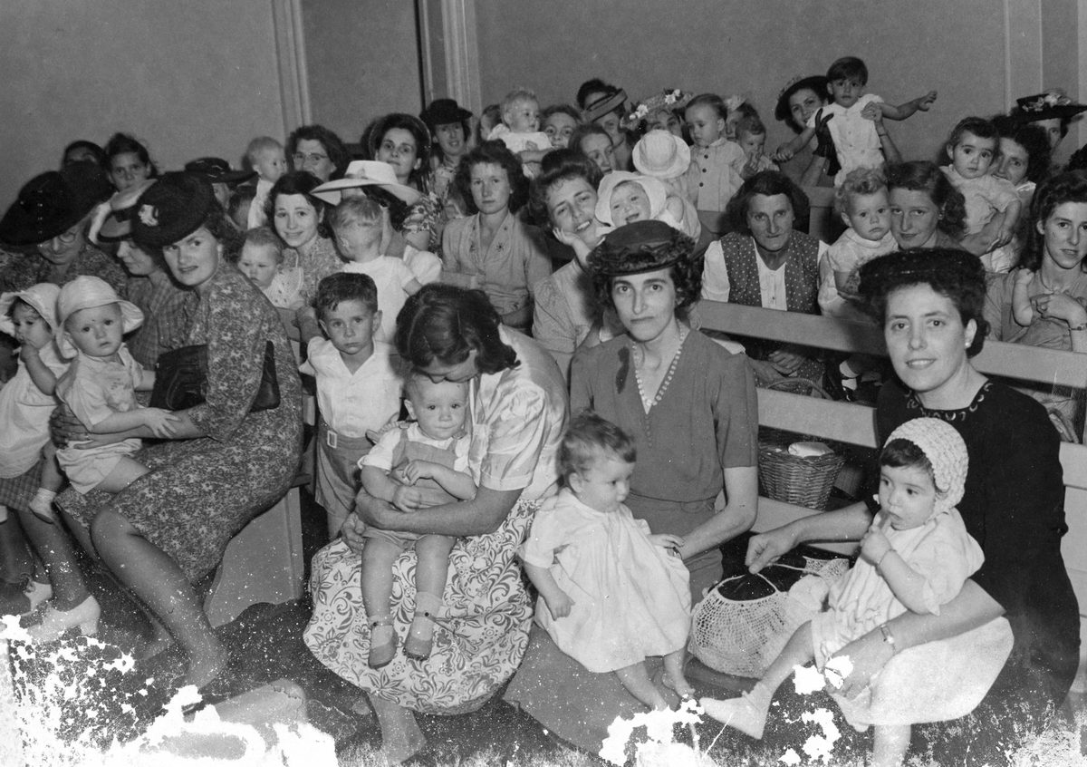 Mothers waiting their turn to have their children vaccinated, City Hall, Brisbane, 1947, Brisbane City