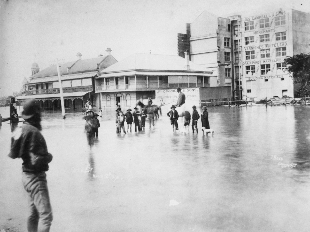 People wade through a flooded Eagle Street Brisbane during the 1980 flood, Brisbane City (1890)