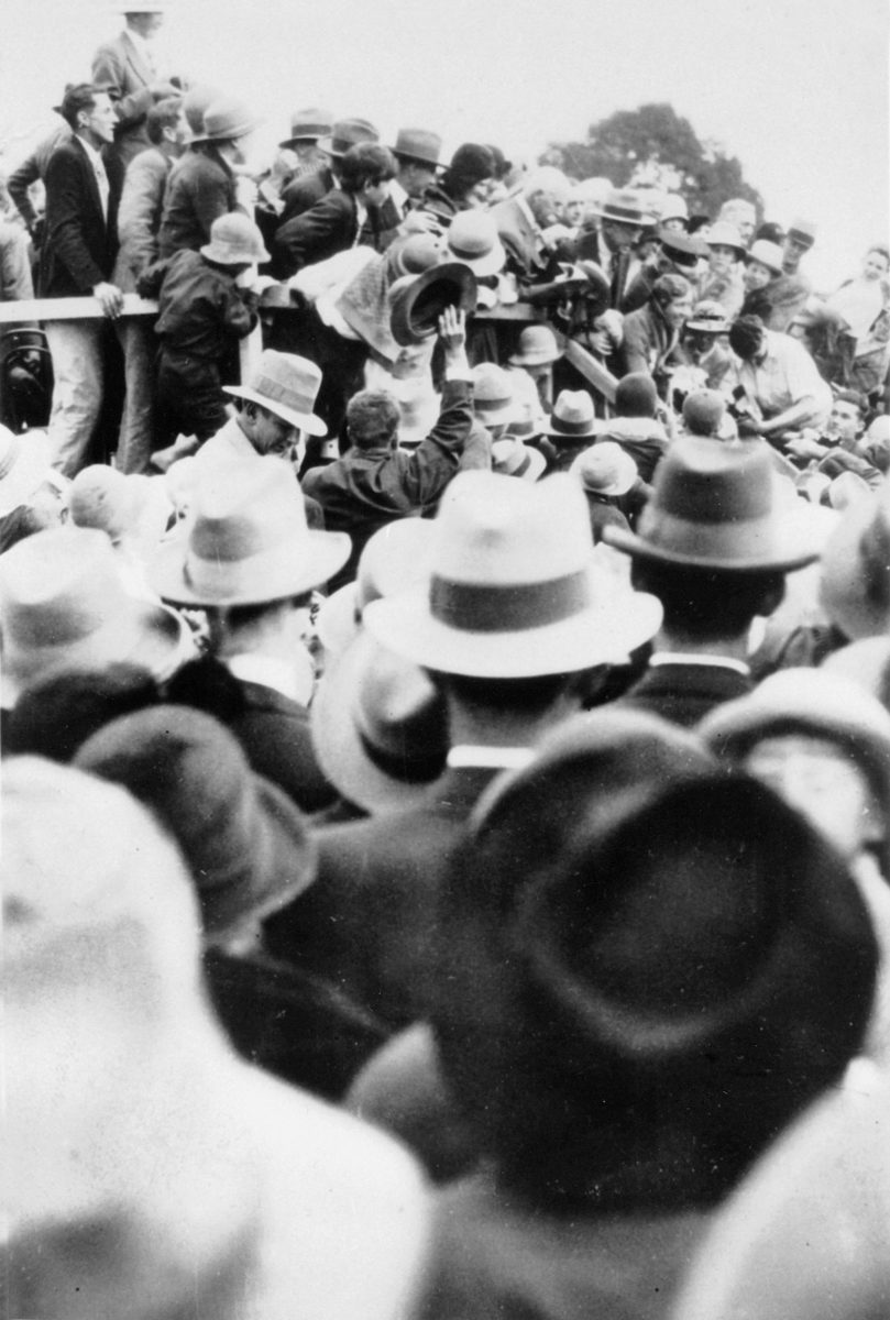 Crowds gather around Amy Johnson after her England to Australia flight in 1930, Eagle Farm