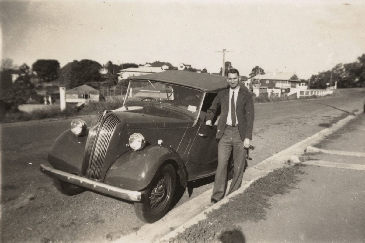 Ronald Douglas standing next to his newly purchased Standard eight horsepower sports tourer, Brisbane, 1950