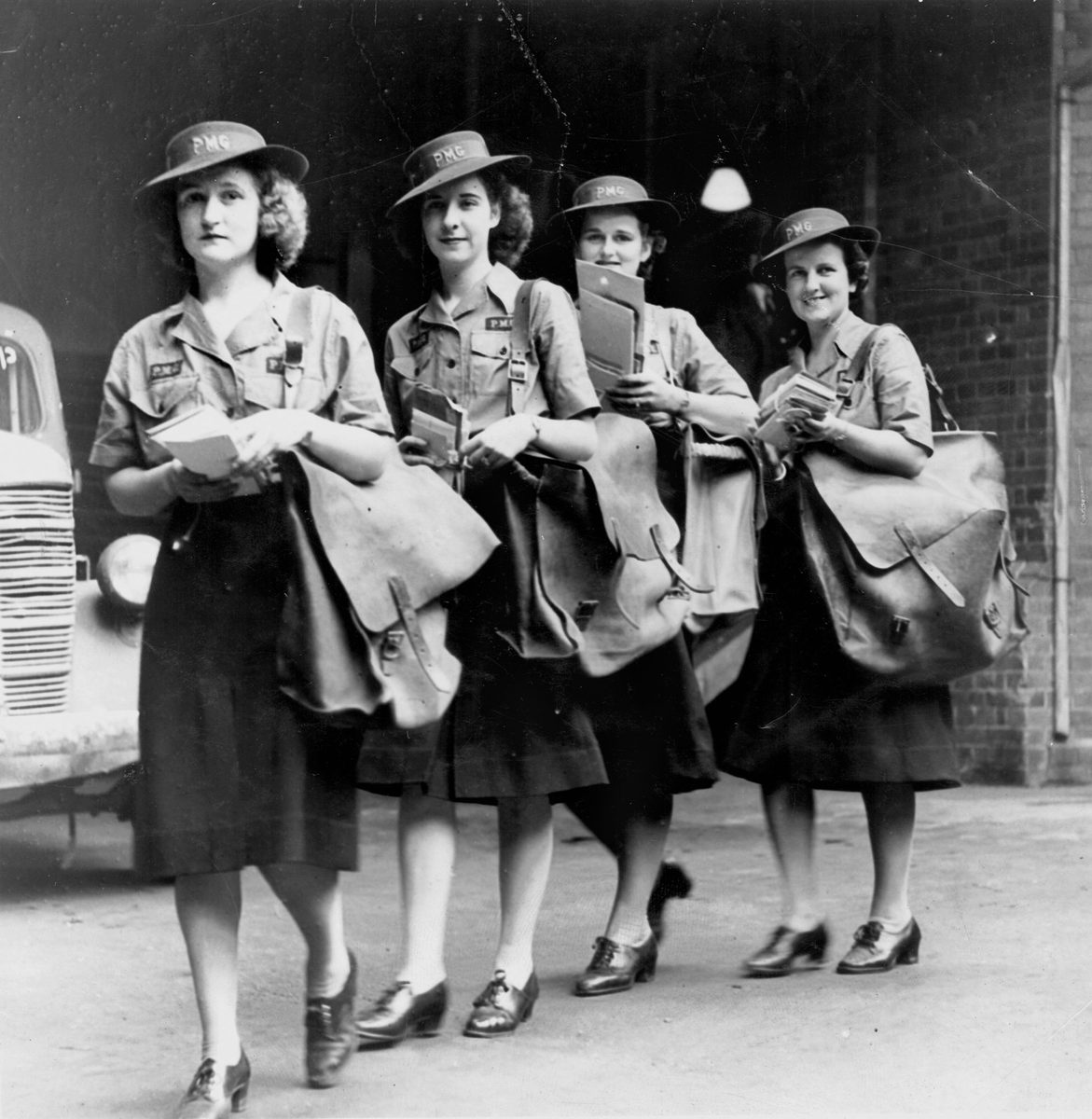 Postwomen with their mail bags and bundles of mail, Brisbane February 1943