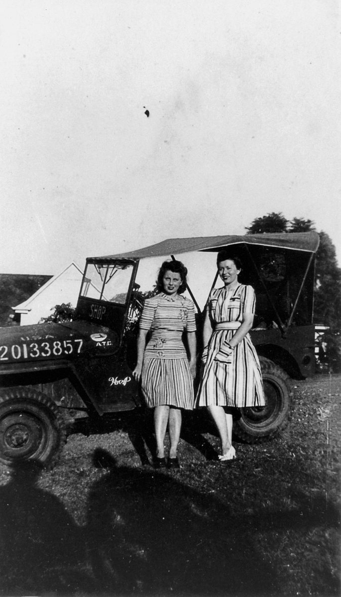 Two young women pictured in front of an American Air Transport Command Jeep, Brisbane, 1944