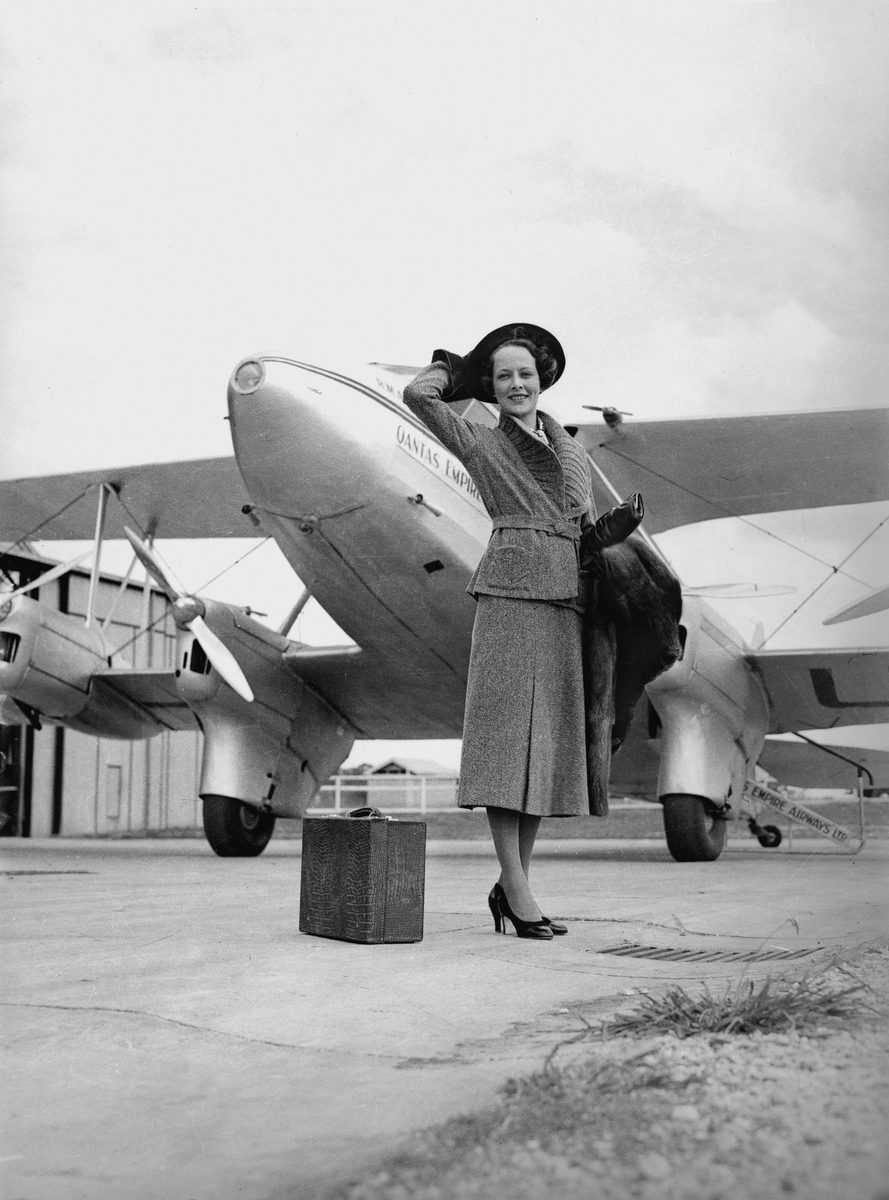 Fashion model posing in front of a Qantas Airlines plane, Brisbane, 1936