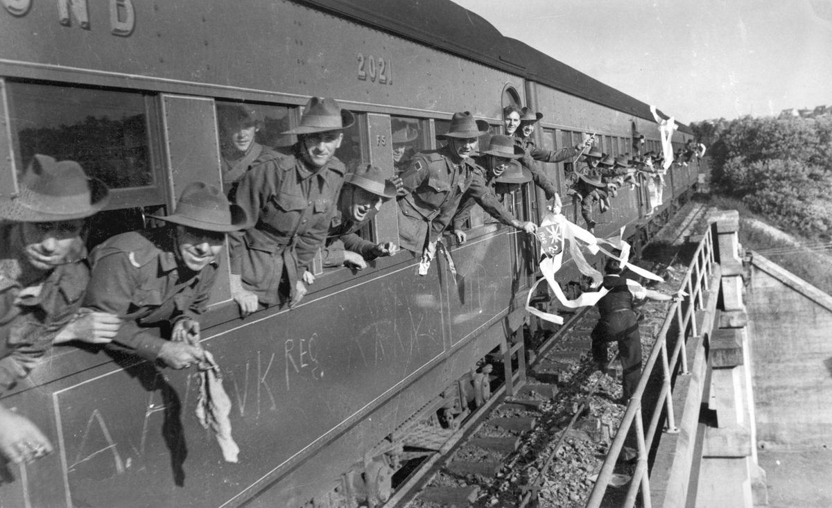 Soldiers waving from the window of a train in Brisbane, Queensland, 1940