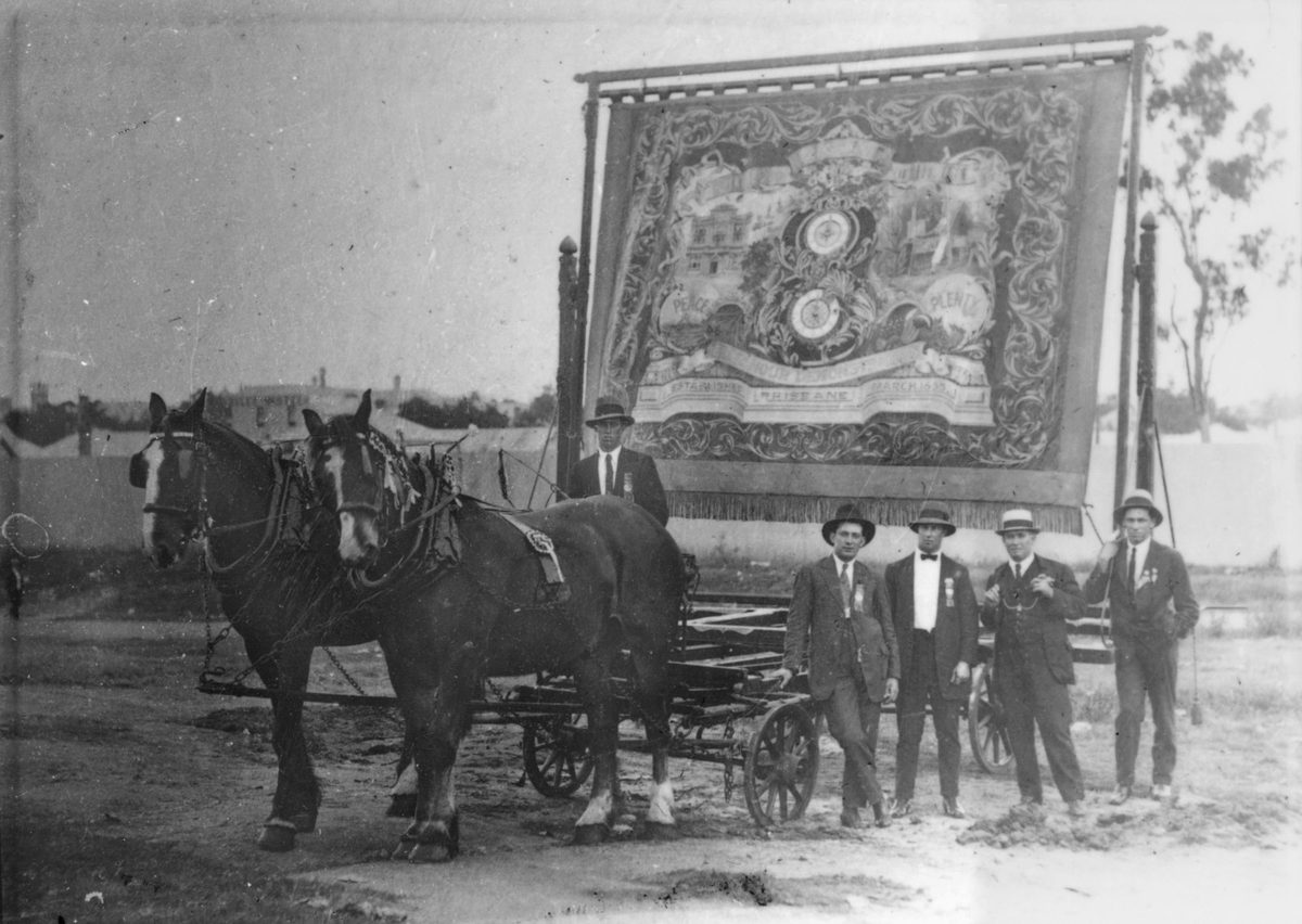 Men posing next to a Labor Day float, Brisbane, 1938