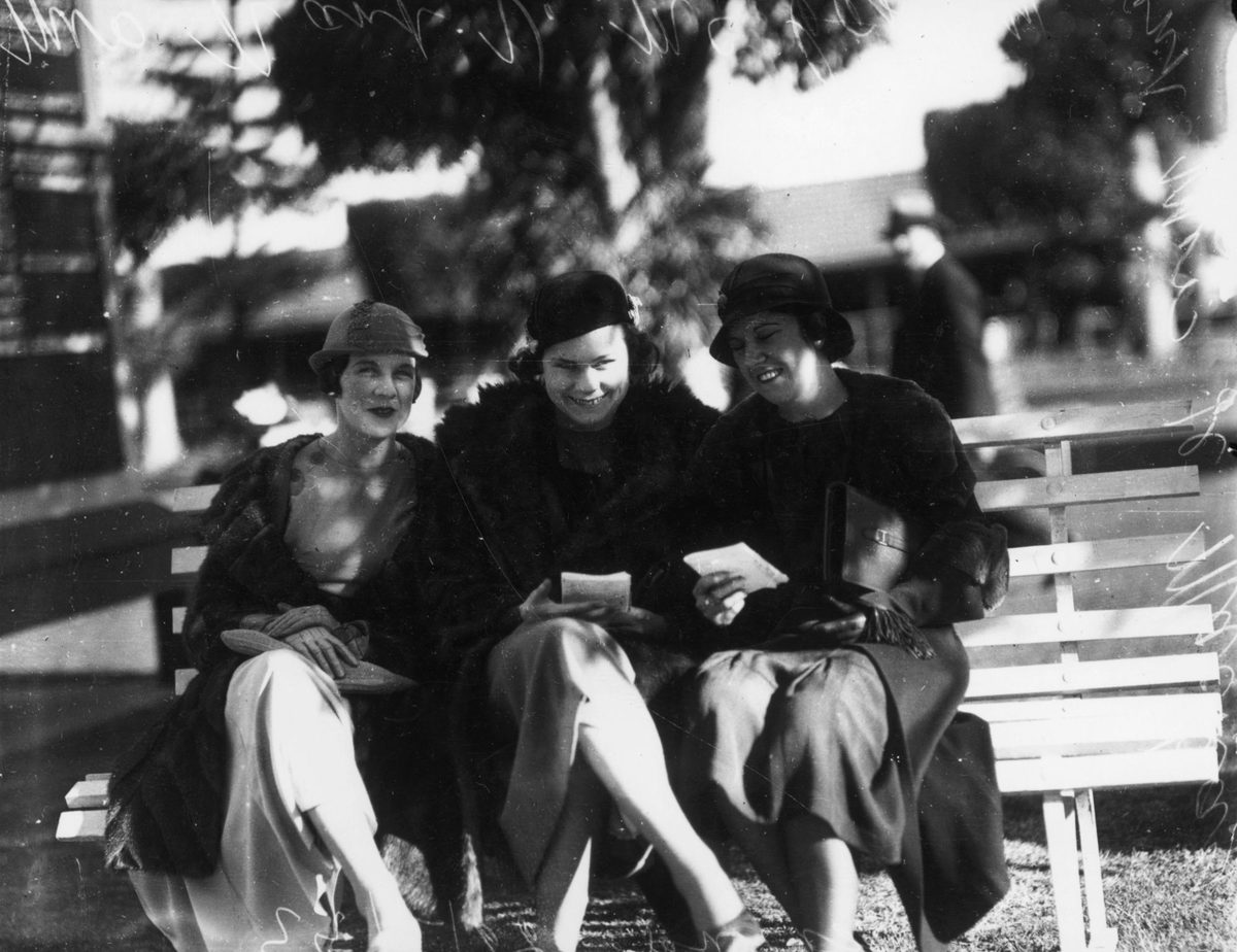 Trio of ladies studying the form at Ascot races, Brisbane, 1933