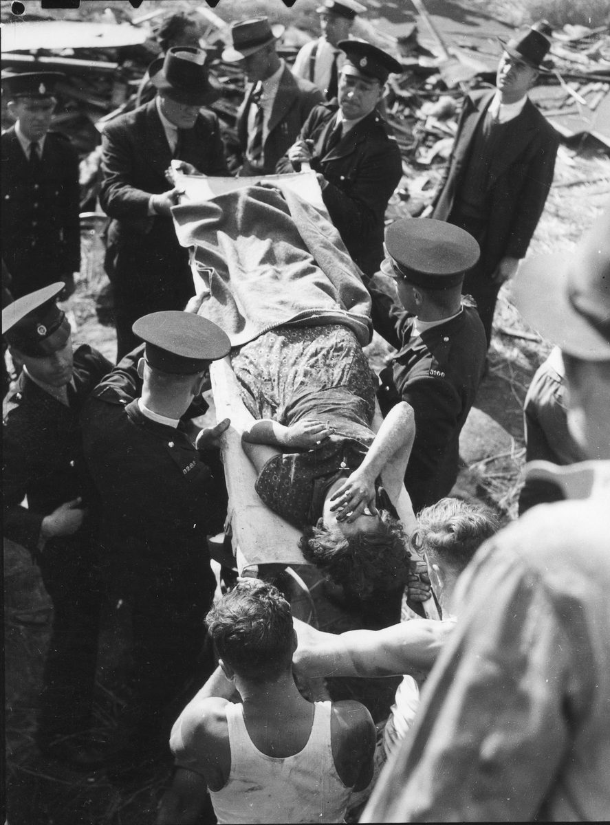 Woman being carried on a stretcher after railway accident at Camp Mountain, Queensland, 1947