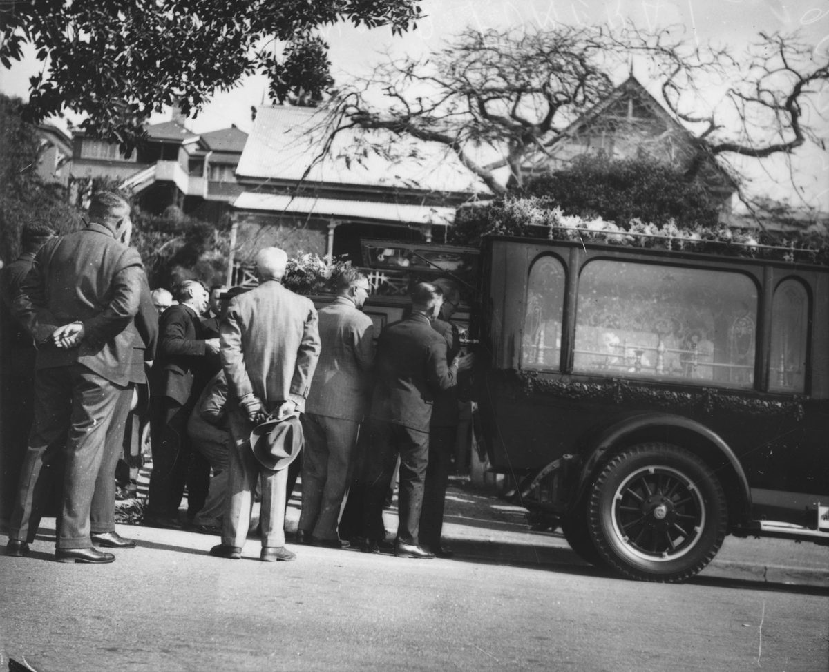 Mourners place Lewis McDonald's coffin into a hearse, Brisbane, 1936