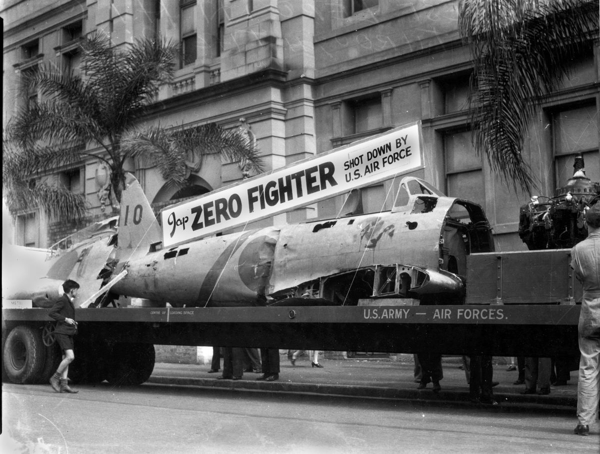 Remains of a Japanese Zero Fighter aeroplane, shot down by the U.S. Air Force, on display in a Brisbane march, July 1943