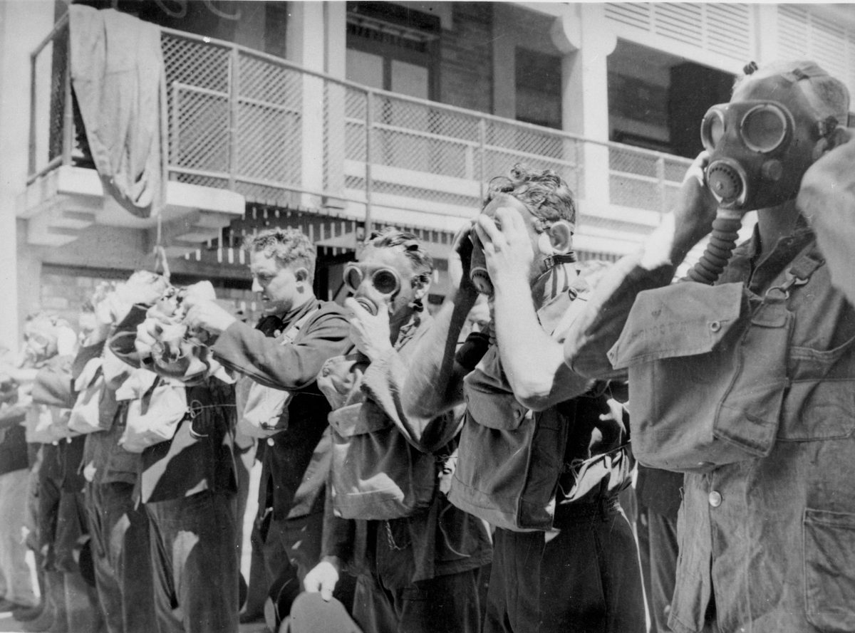 Demonstrators wearing gas masks at the Brisbane City Fire Brigade, Brisbane, 1942