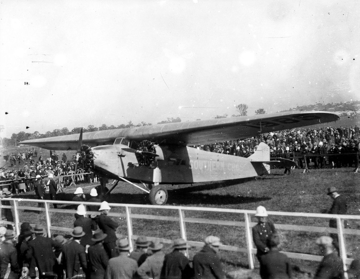 Southern Cross, a Fokker F.VII 3m aeroplane, on display in an enclosure at the airfield, June 1928, Brisbane