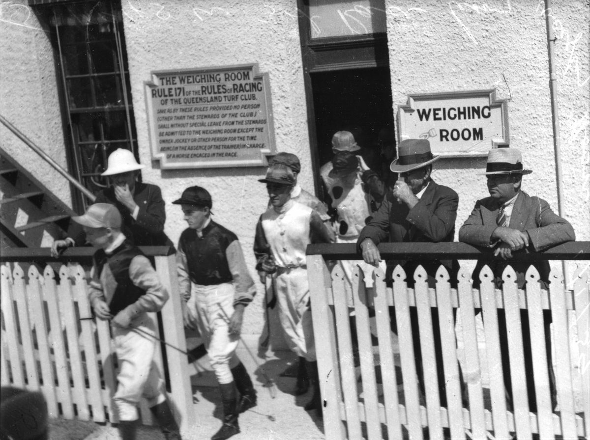 Jockeys on their way to the mounting yard at a race track in Brisbane, 1939
