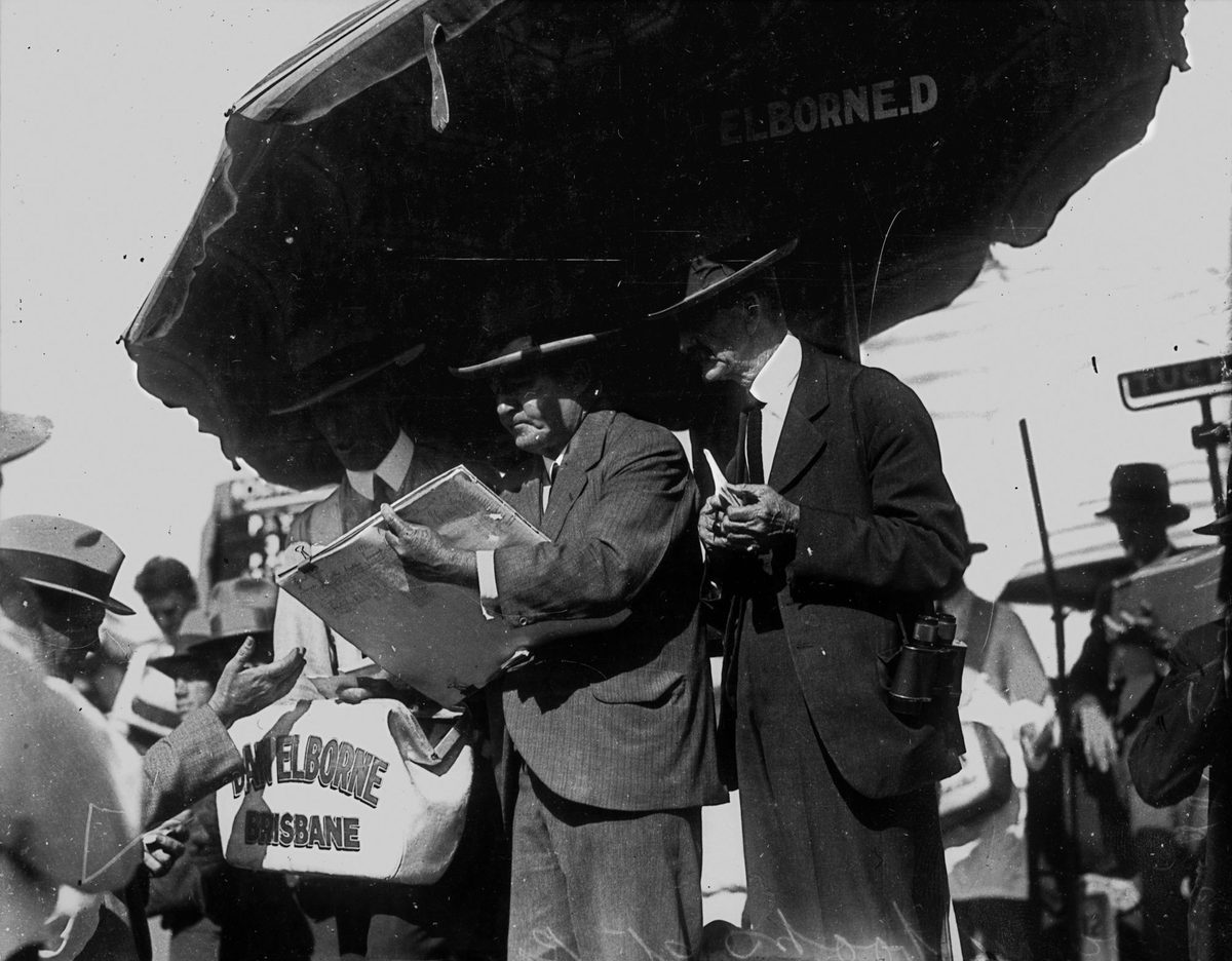 Bookmakers in action in the ring at the races, Brisbane 1932