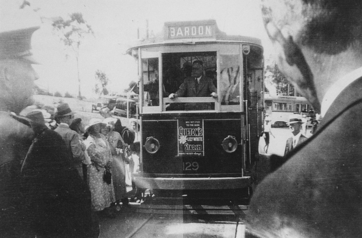 Crowds gather around a Brisbane tram at the opening of the Bardon tram extension, 1937