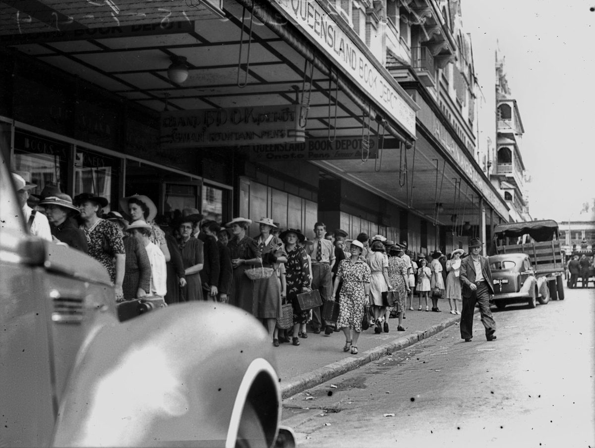 Crowds line the footpath waiting for bacon in Adelaide Street, Brisbane, January 1944, Brisbane City