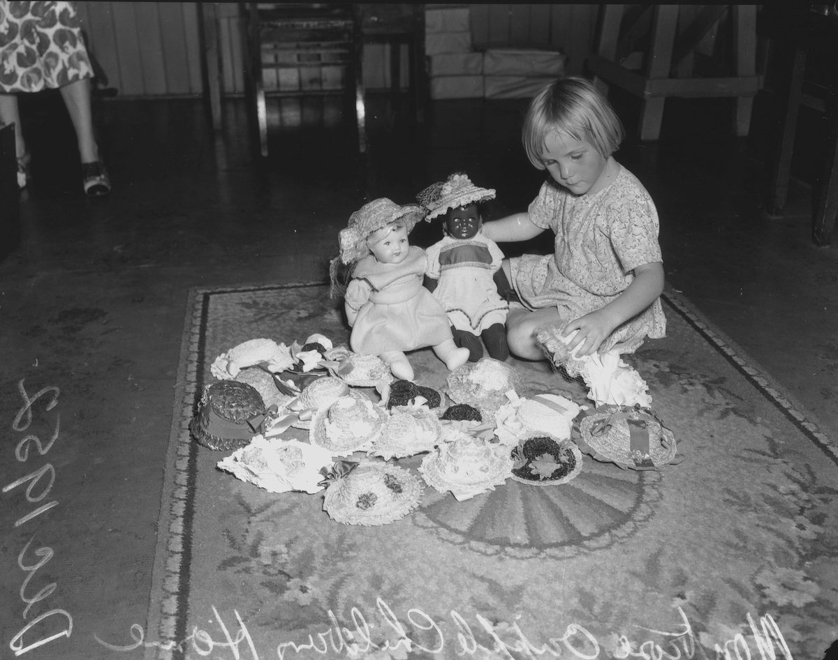Young girl with a disability, playing with her dolls, 1952, Brisbane