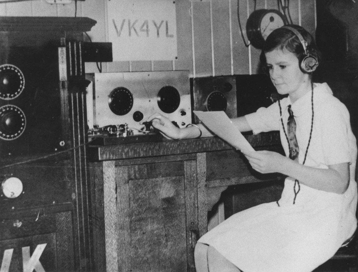 Twelve year old Madeleine Pugh operating a radio in her home at Wynnum, Brisbane, 1934