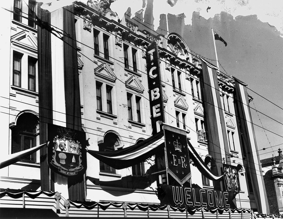 Queensland's Coat of Arms and the Royal Coat of Arms are part of the decorations on the T. C. Beirne building, 1954, Brisbane