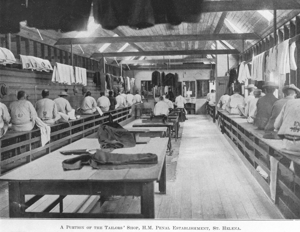 Prisoners making uniforms in the tailors' workshop on St Helena Island, 1911