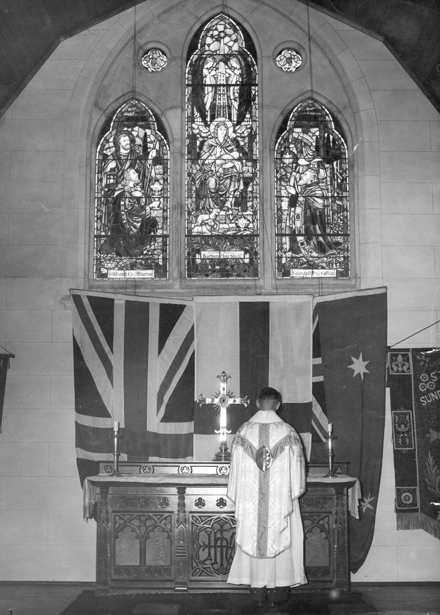 Reverend A. E. Loxton at the altar of St. Thomas' Church of England, Toowong, 1952