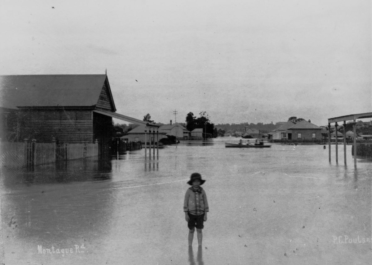 Child standing ankle deep in flooded Montague Road, West End, Brisbane, 1890