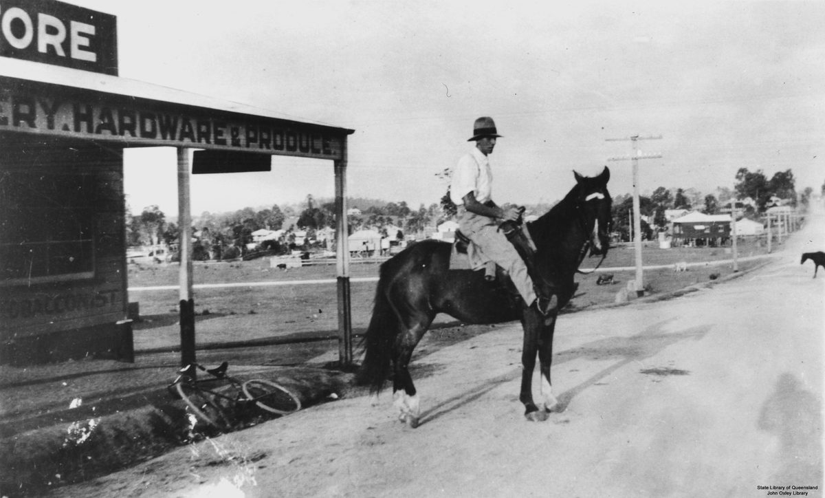 Man on horse outside general store in Mitchelton, Brisbane, 1927
