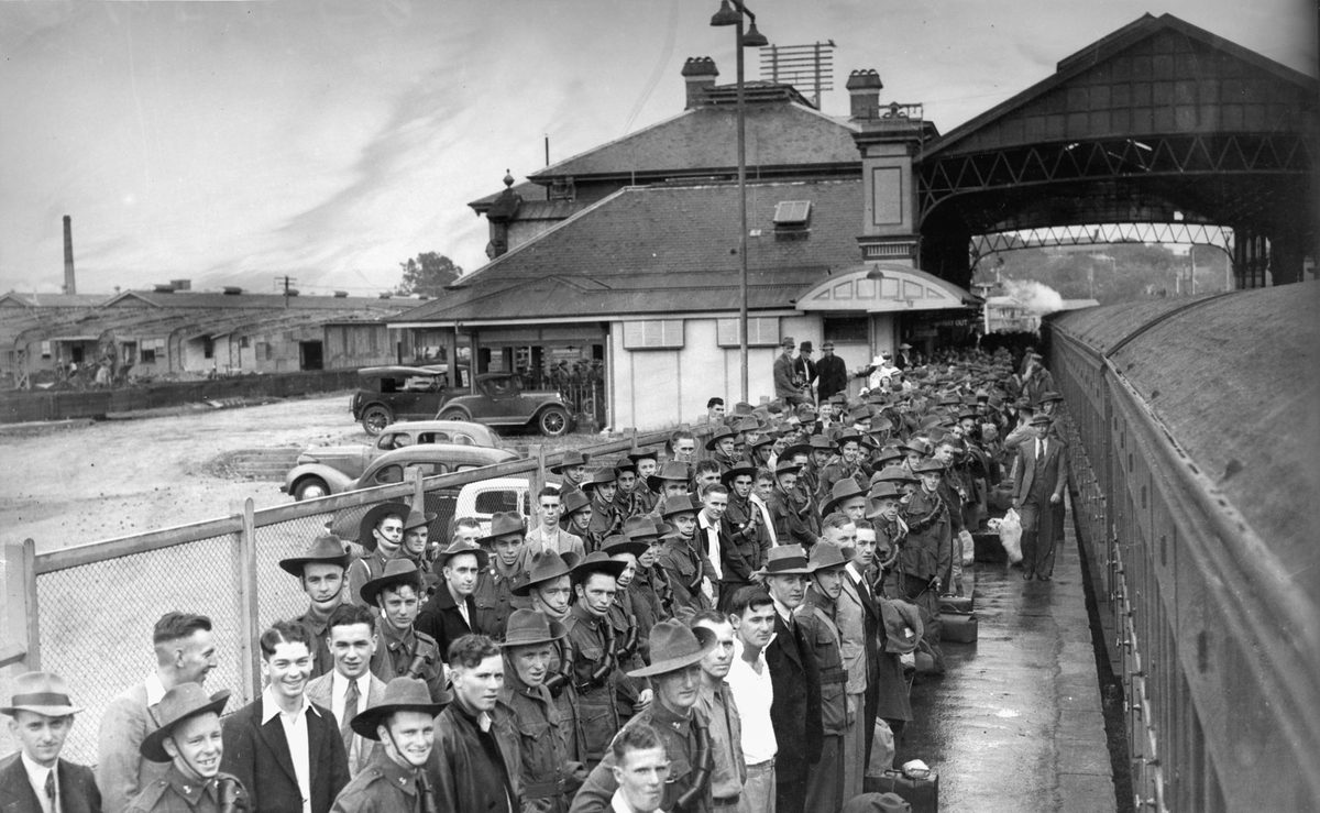 Trainee soldiers at Roma Street Station, Brisbane, waiting to embark on a train to Caloundra Camp during World War II, 1940, Brisbane City