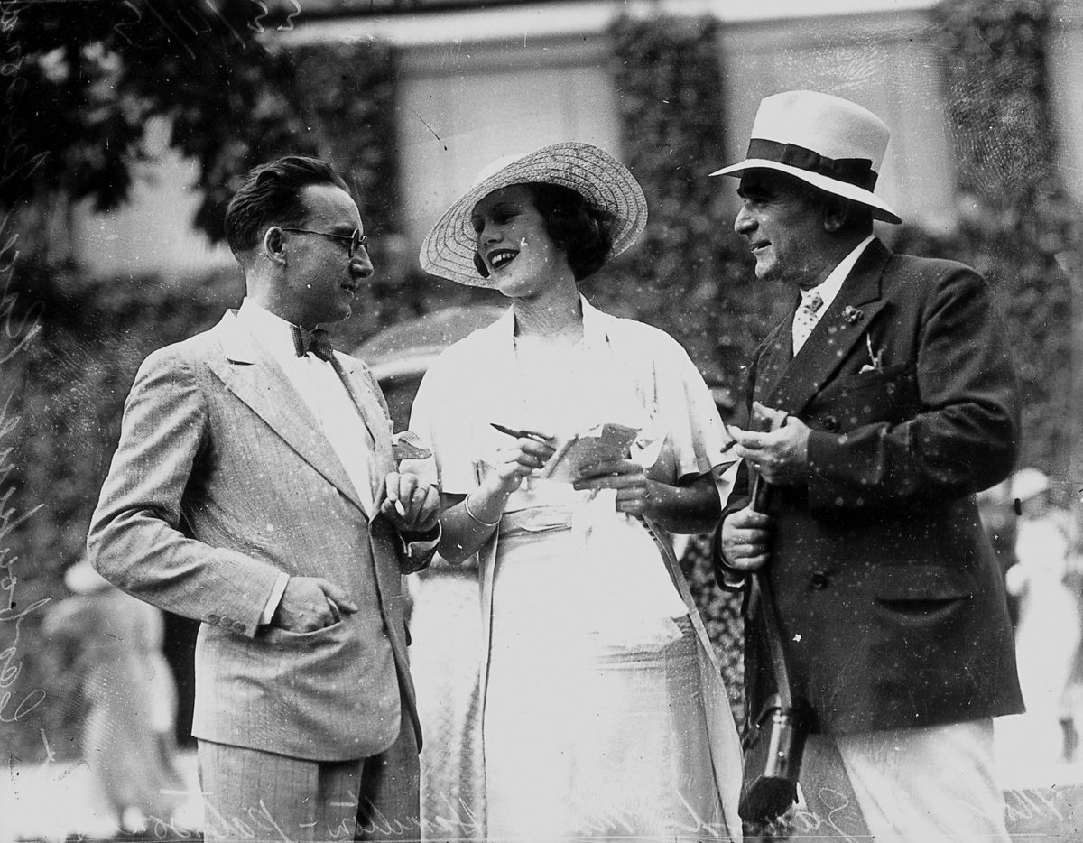 Mary Hamilton-Paterson chatting with two gentlemen at the races, Brisbane, November 1933