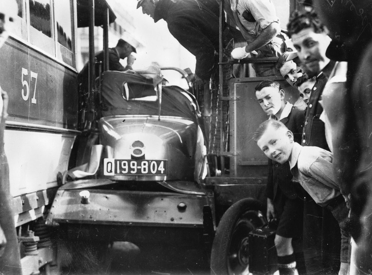 Motorist squashed between two early electric trams, Brisbane, 1935