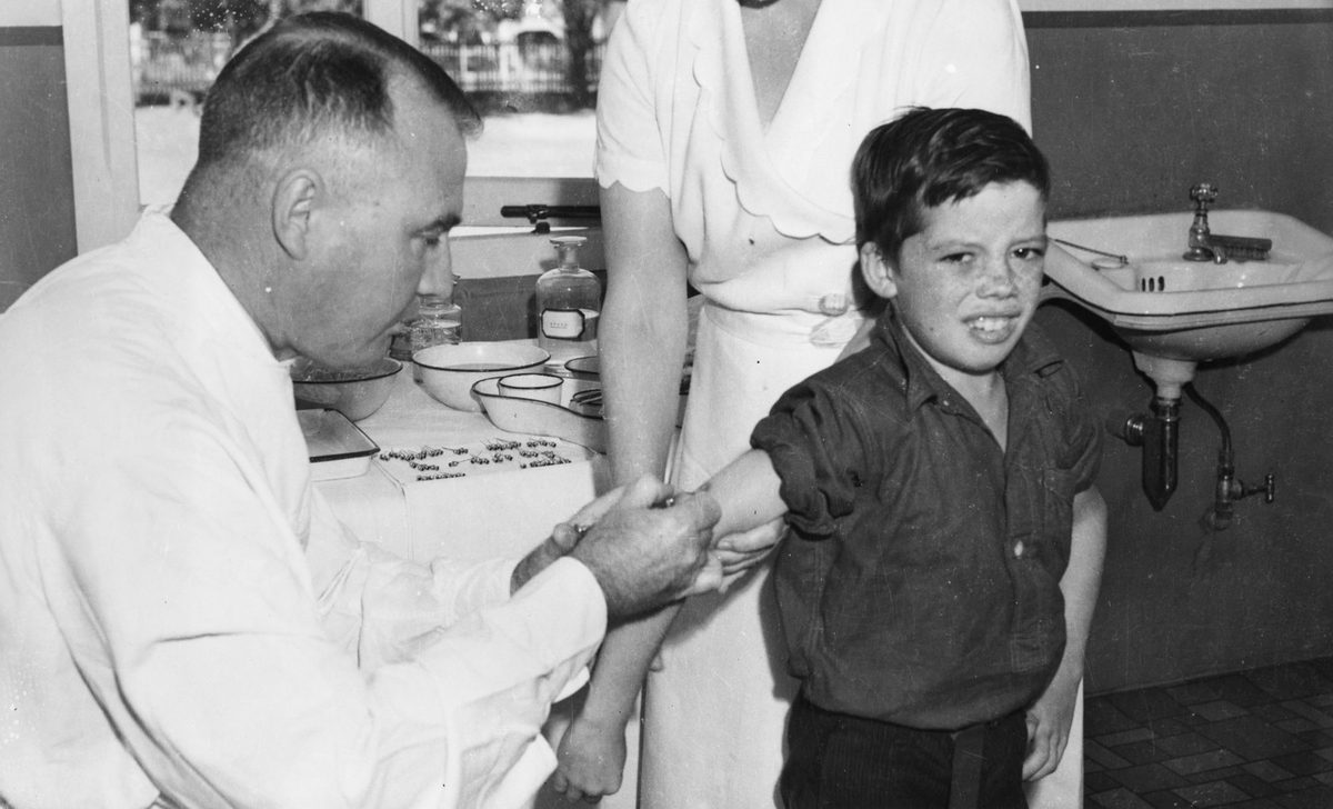 Young schoolboy being vaccinated for Diphtheria, Brisbane, 1940