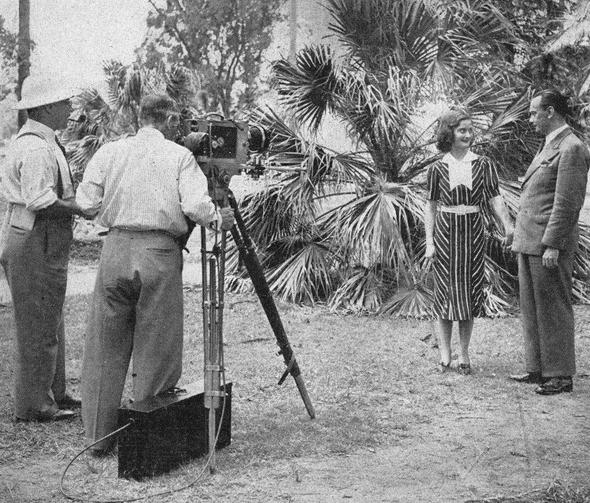 Filming in the Brisbane Botanic Gardens of actors Beenie Grant and Howard Broadbent by cameraman Tasman Higgins, 1938