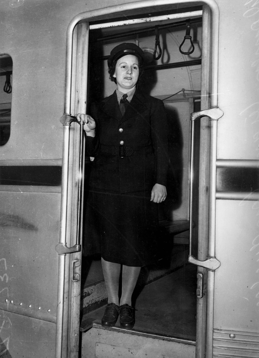 Tram Conductress in her new uniform pictured standing in the doorway of a tram, Brisbane, 1942