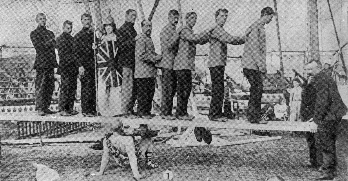 Circus strongman supporting ten people on a plank, Brisbane, 1903
