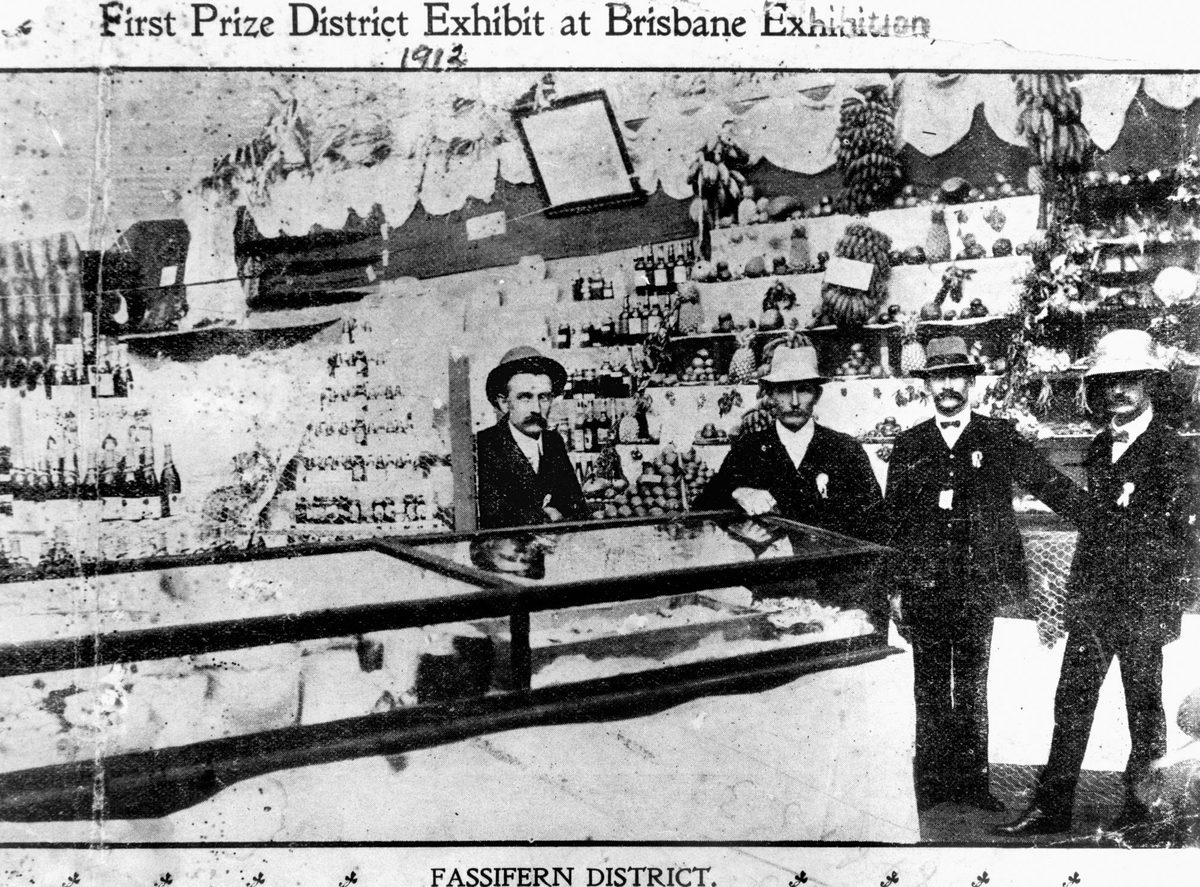 Four gentlemen inspect the Fassifern District Exhibit which won first prize at the Brisbane Exhibition, 1912, Bowen Hills