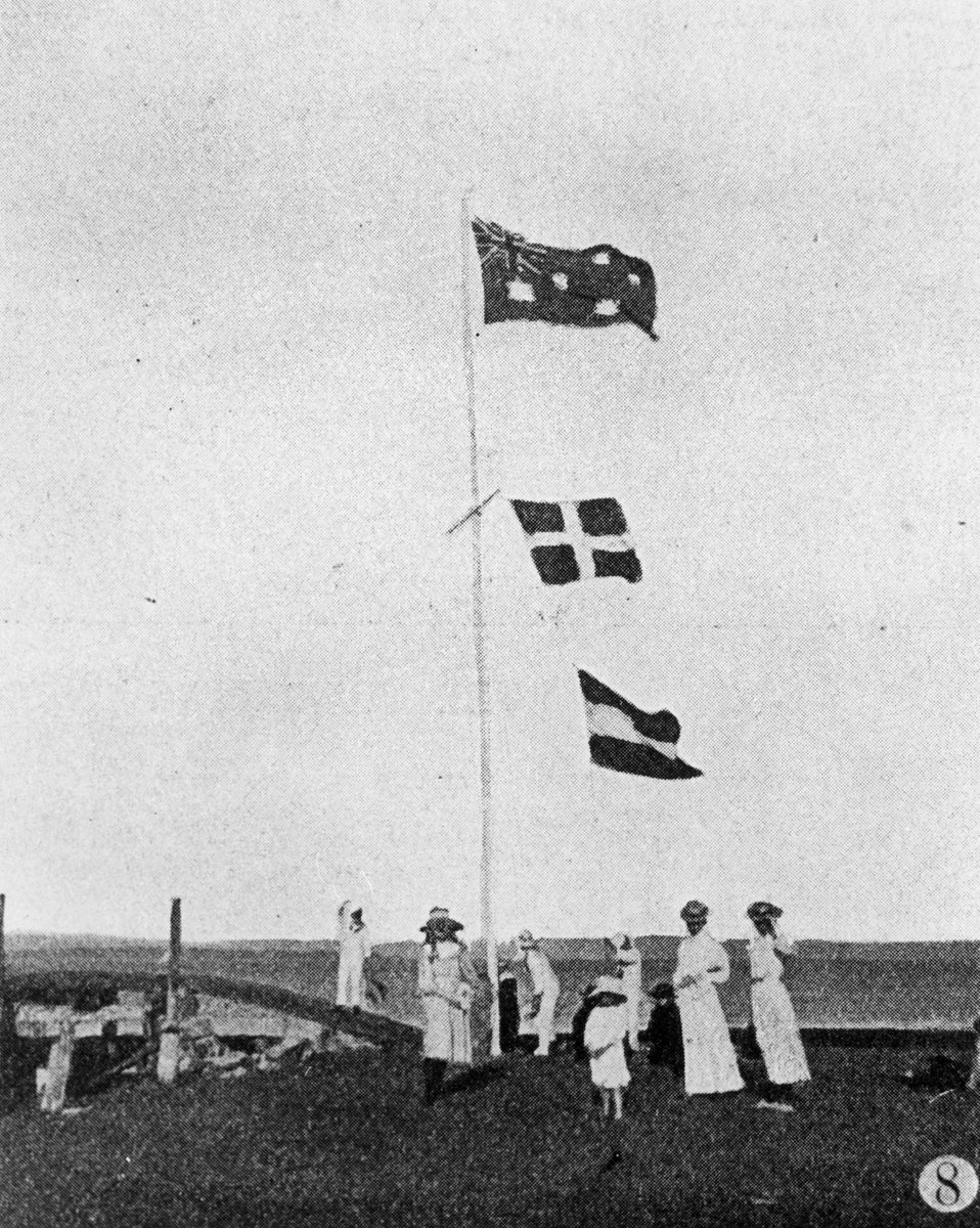 Women and children standing beneath the flagpole at the Signal Station, Cleveland Point, 1907