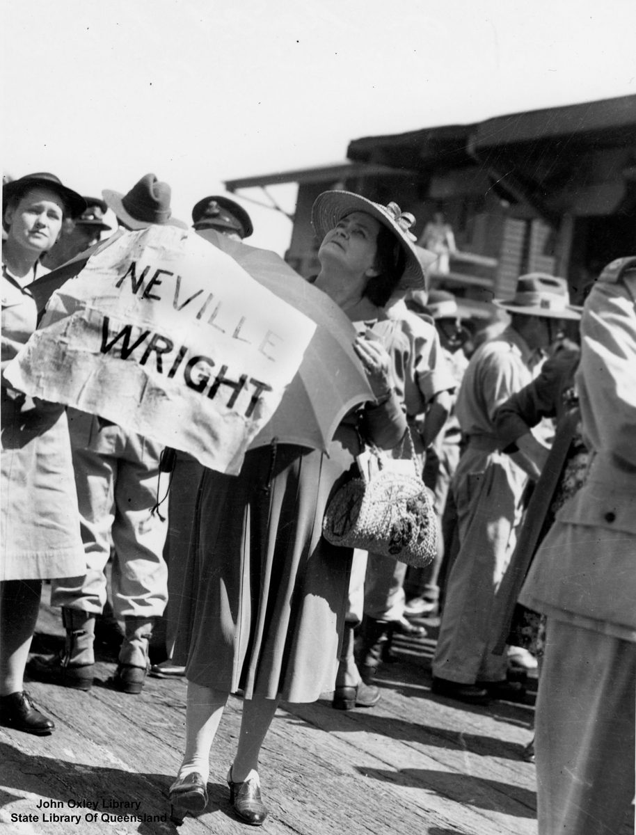 Woman waiting on a Brisbane wharf for her son, a returning prisoner of war (1945)