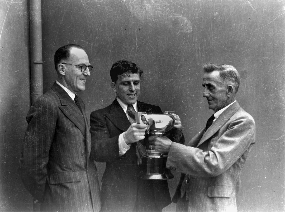 Jack Kellaway is presented with a Rugby League cup in October 1944, Brisbane