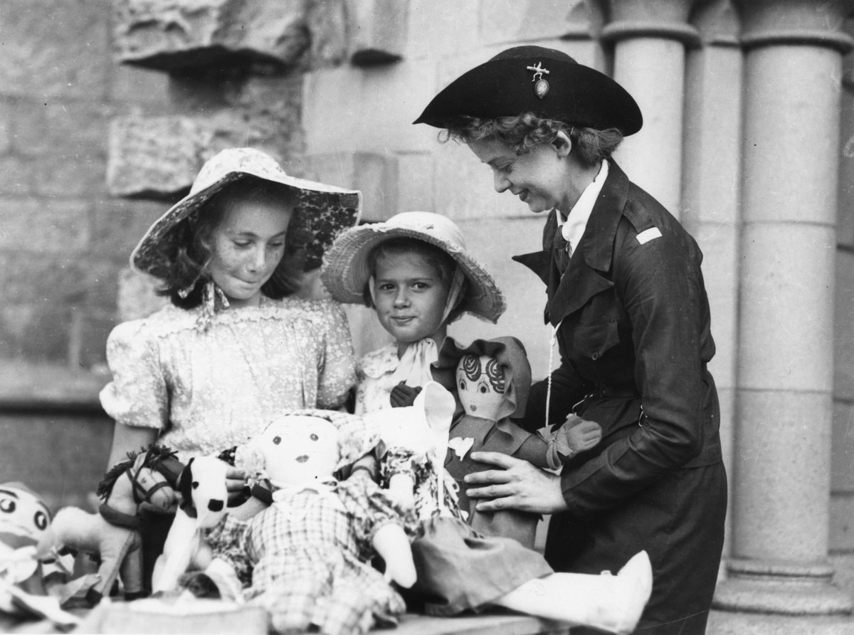 Two young girls looking at the toys for sale at the fete, Brisbane, 1945