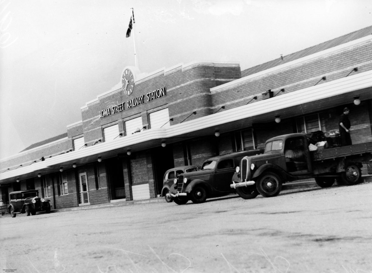 Motor vehicles parked in front of the Roma Street Railway Station, Brisbane, 1940, Brisbane City
