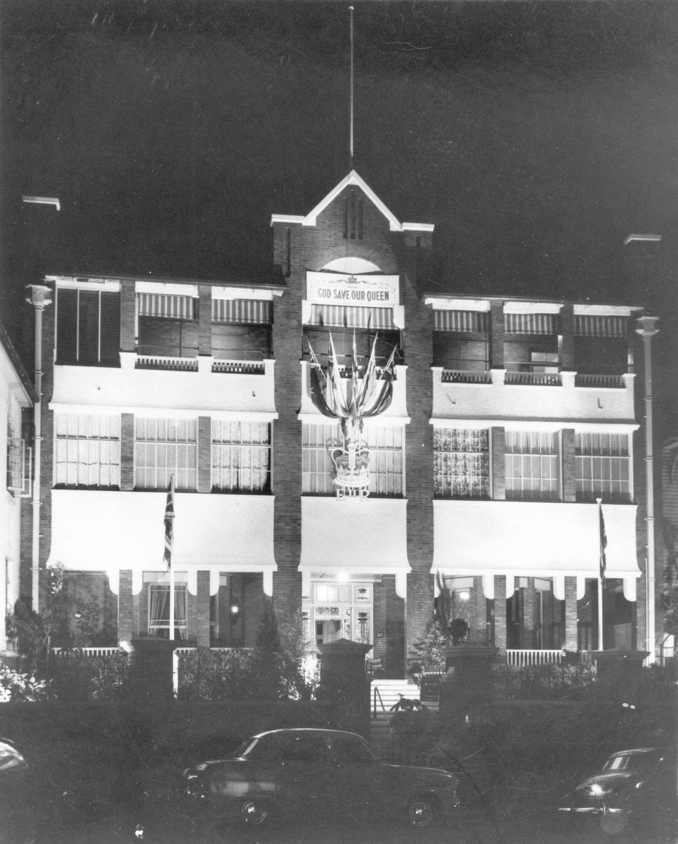 External view of the United Service Club premises on Wickham Terrace decorated for the royal visit, Brisbane, 1954, Brisbane City