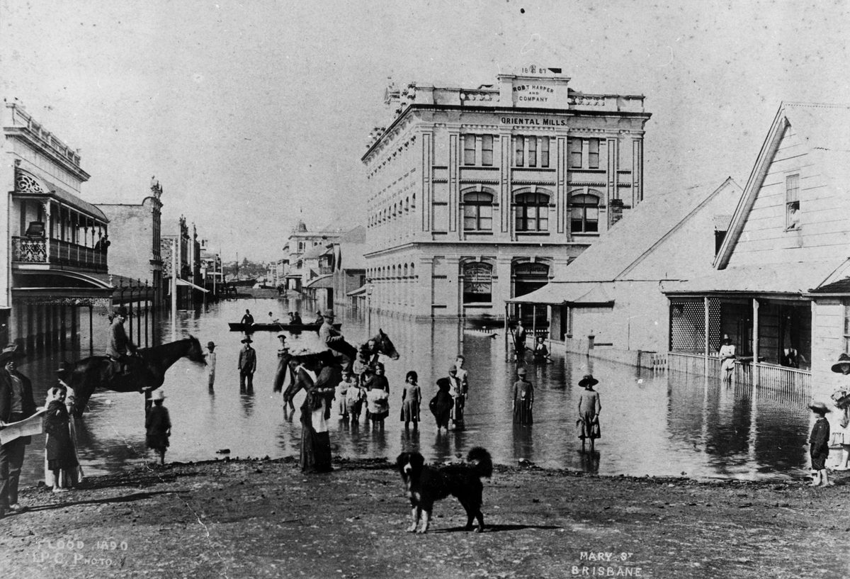 Children demonstrating the depth of flood waters in Mary Street, Brisbane, during the 1890 flood, Brisbane City