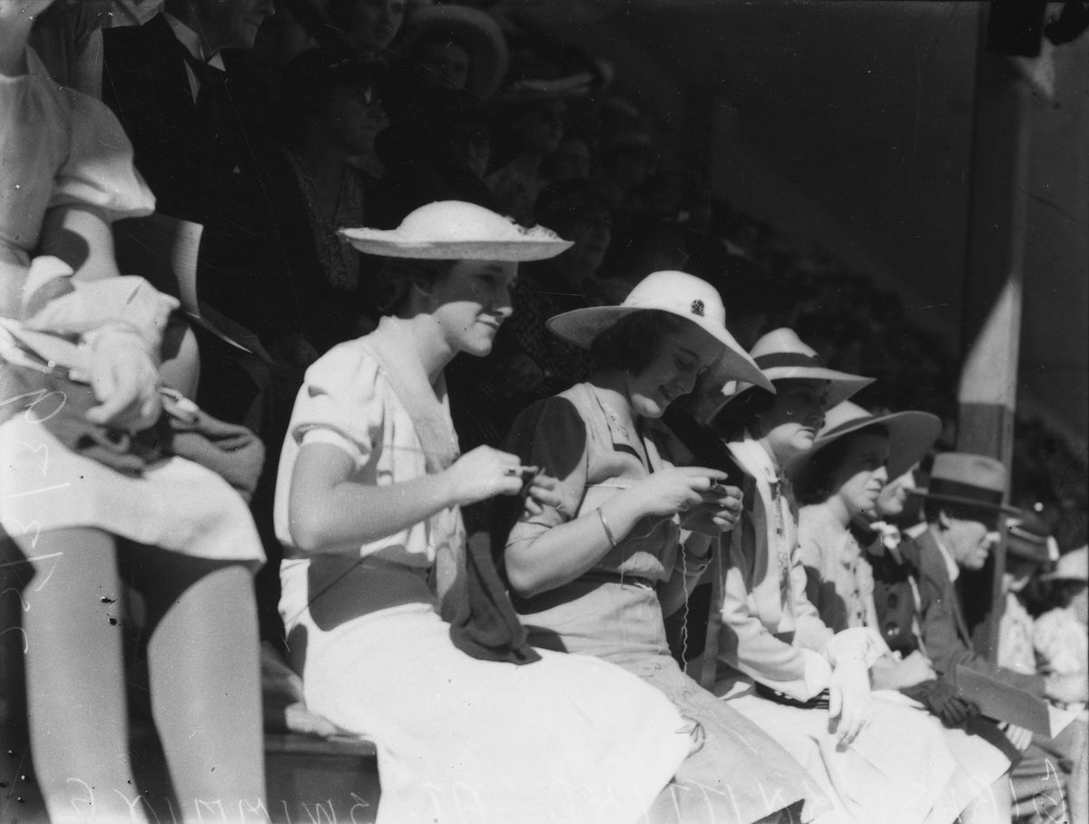 Young ladies getting their knitting done at the swimming carnival, Brisbane, 1939